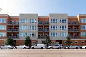 Chicago apartment for rent - a large apartment building with cars parked in front of it  at Tripp 4321, Chicago, 60641