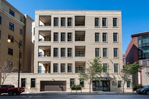 Chicago apartment for rent - A large building with a garage door and a sign that says