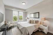 Barrington apartment for rent - a white bedroom with a bed and a tv at Barrington 101, Illinois