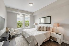 Barrington apartment for rent - a white bedroom with a bed and a tv at Barrington 101, Illinois