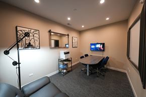 Highwood apartment for rent - a conference room with a table and a tv