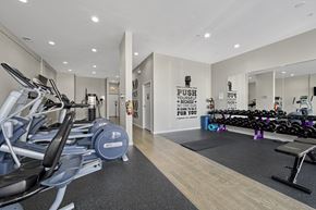 Chicago apartment for rent - A gym with a row of treadmills and a sign that says