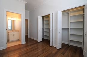 Chicago apartment for rent - a bedroom with a closet and a sink and a mirror