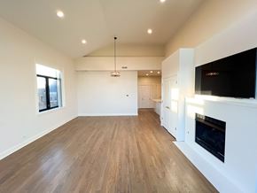 Chicago apartment for rent - A spacious living room with a fireplace and a television.