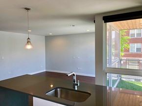 Chicago apartment for rent - an empty kitchen with a sink and a window
