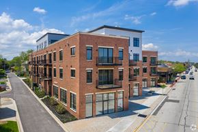 Highwood apartment for rent - A street view of a row of modern brick apartment buildings.