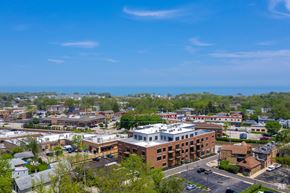 Highwood apartment for rent - an aerial view of a city with buildings and the ocean in the background