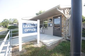 Monroeville apartment for rent - A leasing office is located in a small building with a stone wall.