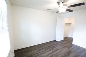 Monroeville apartment for rent - A room with a ceiling fan and a door.