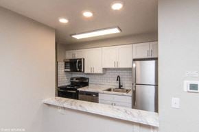 Denver apartment for rent - Breakfast bar sitting area and subway tile backsplash in the kitchen at 1354 High in Denver, CO