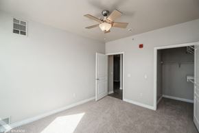 Denver apartment for rent - a bedroom with a ceiling fan and a door to a closet