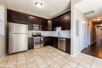 Chicago apartment for rent - a large kitchen with stainless steel appliances and wooden cabinets
