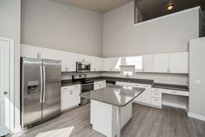 Denver apartment for rent - a large kitchen with stainless steel appliances and white cabinets