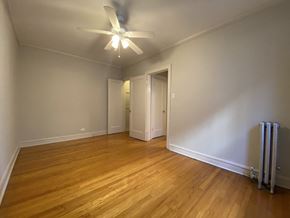 Chicago apartment for rent - Bedroom with ceiling fan - Charlie Chaplin One Bedroom