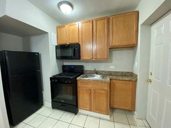 Black appliances including a built-in microwave