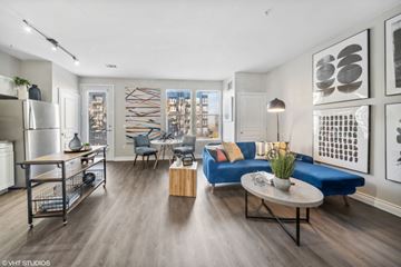 Denver apartment for rent - A modern living room with a blue couch and a coffee table.