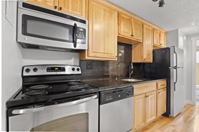 Denver apartment for rent - A kitchen with a stove, oven, microwave, and refrigerator at 23–33 Pearl St in Denver, CO