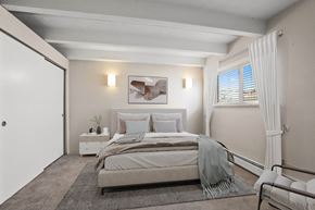 Denver apartment for rent - Tranquil and inviting, this spacious bedroom features soft lighting, neutral tones, and serene views at 1140–1160 S Bellaire St in Denver, CO