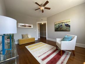 Chicago apartment for rent - A living room with a white chair and a rug.