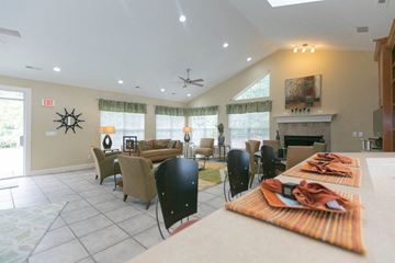 Williamsburg apartment for rent - A living room with a fireplace and a dining table set for a meal.