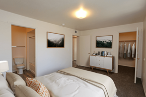 Albuquerque apartment for rent - A bedroom with a bed, a cabinet, and two pictures on the wall.