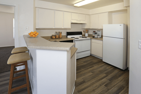 Albuquerque apartment for rent - A kitchen with white cabinets and a white refrigerator.