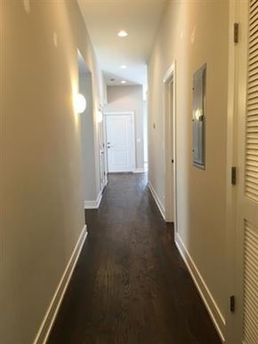 Chicago apartment for rent - a hallway with a wood floor and white walls