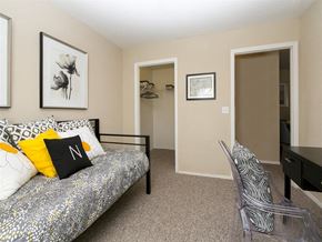 Panama City apartment for rent - A bedroom with a bed, chair, and two pictures on the wall.