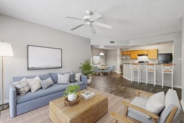 Jacksonville apartment for rent - A living room with a blue couch and a wooden coffee table.