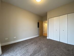 Chicago apartment for rent - an empty living room with carpet and white cabinets