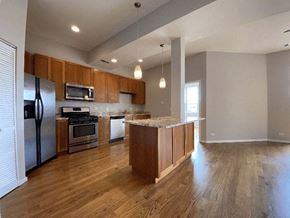 Chicago apartment for rent - an empty kitchen with wood floors and stainless steel appliances
