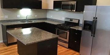 Chicago apartment for rent - a kitchen with granite counter tops and stainless steel appliances