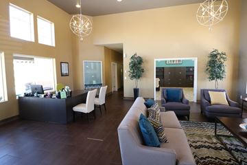 Albuquerque apartment for rent - A living room with a grey couch and a black desk.