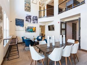 Denver apartment for rent - A dining room with a long table and chairs.