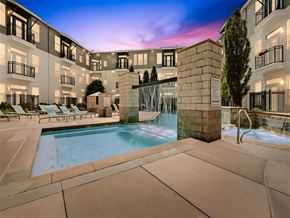 Denver apartment for rent - a swimming pool with a fountain in front of an apartment building