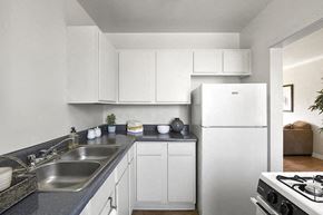 Los Angeles apartment for rent - a white kitchen with a sink and a refrigerator