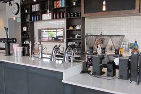 Denver apartment for rent - A bar with a coffee machine and a shelf with bottles at Wash Park Station in Denver, CO