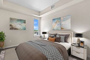 Denver apartment for rent - A bedroom with a large bed and two paintings on the wall at Wash Park Station in Denver, CO