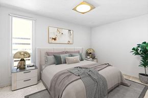 Denver apartment for rent - A bedroom with a large bed and a painting above it.
