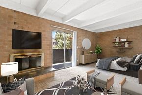 Glendale apartment for rent - A modern living room with a fireplace and a television at The Helix in Denver, CO