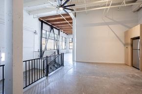 Los Angeles apartment for rent - the lobby of a building with a concrete floor and white walls
