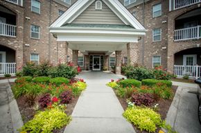 Virginia Beach apartment for rent - A building with a white roof and a walkway in front of it.