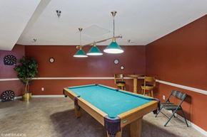 Newport News apartment for rent - A pool table in a room with a brown wall.