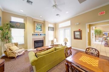 Jacksonville apartment for rent - A living room with a green couch and a fireplace.