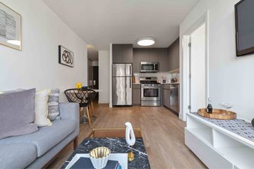 Chicago apartment for rent - A modern living room with a grey sofa and a coffee table with a bowl on it.