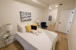 Calgary apartment for rent - Bright Douglas Place bedroom with modern decor and seating area