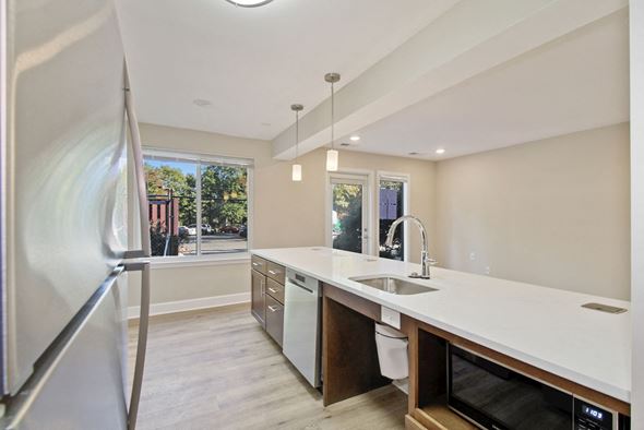 Derwood townhouse for rent - A modern kitchen with a refrigerator on the left and a microwave on the right.