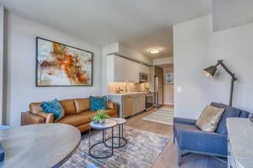 Silver Spring apartment for rent - a living room with a couch and a table and a kitchen