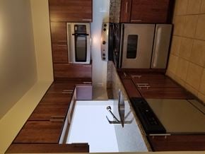 Bethesda apartment for rent - A kitchen with wooden cabinets and a white counter top.