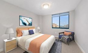 Silver Spring apartment for rent - A bedroom with a large bed and a painting on the wall.